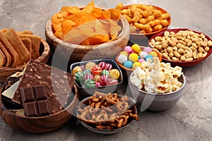 Salty snacks. Pretzels, chips, crackers in wooden bowls.