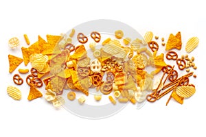 Salty snacks texture on a white background. Party food mix. Potato chips etc