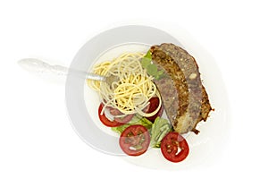 Salty spicy slice Meatloaf beef served  with spaghetti and lettuce salad with tomato .fork tangled in spaghetti accompanying a