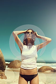 Salty but sweet. an attractive young woman enjoying a day on the beach.