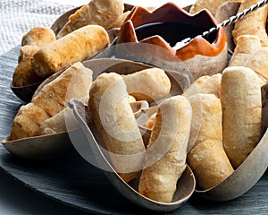 Salty white cheese wrapped in fried wheat flour and sugar cane molasses tequeÃÂ±os photo