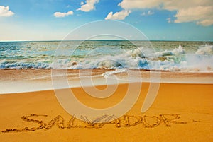 SALVADOR, BAHIA, BRAZIL: Inscription on the sand city of Salvador, drawing on the beach