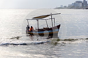 Fishing boat arriving at Rio Vermelho beach in the city of Salvador, Bahia