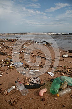 Plastic and garbage on the beach sand photo