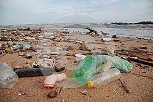 Plastic and garbage on the beach sand photo