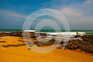 SALVADOR, BAHIA, BRAZIL: Tropical landscape on the Itapua beach with rocks by the sea in Sunny weather