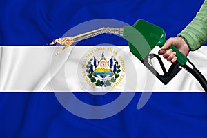 SALVADOR flag Close-up shot on waving background texture with Fuel pump nozzle in hand. The concept of design solutions. 3d