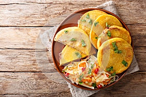 Salvadoran pupusa served with curtido closeup. horizontal top view