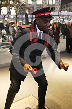 Salvation Army soldier performs for collections in midtown Manhattan.