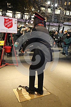 Salvation Army soldier performs for collections in midtown Manhattan.