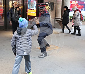 Salvation Army soldier performs for collections in midtown Manhattan.