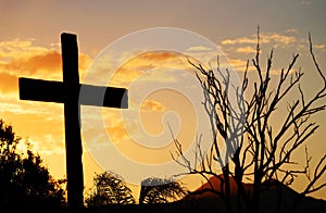 Salvation cross of Christ on hill at sunset photo