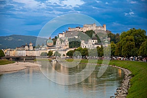 Salzburg, Austria, August 15, 2022. Golden hour shot towards the historic center. Highlighted is the fort at the top of the hill