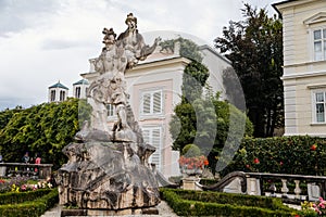 Salzburg, Austria, 28 August 2021: Famous Mirabell gardens near palace, geometrically arranged park, Baroque stone statue of the