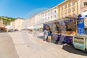 Market stall with pretzels brezen on the market at University  square Universitatsplatz, Salzburg, Austria