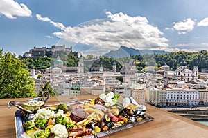 Salzburg city with gastronomic experience of typical Austrian food against downtown in Austria photo