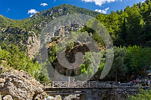 SAMARIA GORGE, CRETE - 20 JULY 2021: Hikers in the spectacular mountain and forest scenery of the Samaria Gorge on the Greek