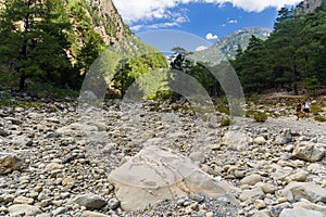 SAMARIA GORGE, CRETE - 20 JULY 2021: Hikers in the spectacular mountain and forest scenery of the Samaria Gorge on the Greek