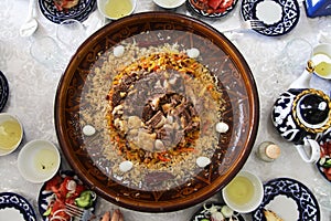 Samarkand pilaf with quail eggs on a ceramic dish in a restaurant