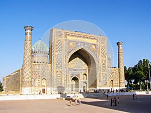 SAMARKAND, UZBEKISTAN - AUGUST 17 2018: People in front of Sher-Dor madrasah of Registan