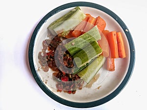 Sambal and lalap, carrot and cucumber as salad, on white background