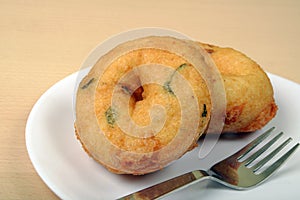 Sambar vada with sambar and coconut chutney a South Indian food, on wooden background