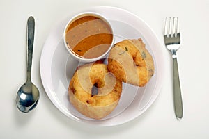 Sambar vada with sambar and coconut chutney a South Indian food, on wooden background