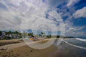 SAME, ECUADOR - MAY 06 2016: Beautiful view of the beach with sand, and builsings behind in a beautiful day in with sunny weather