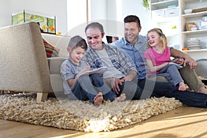 Same sex couple at home with children