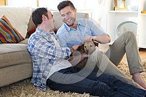 Same sex couple at home with dog