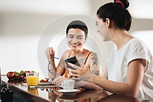 Same Sex Lgbt Partners Eating Breakfast And Watching Videos