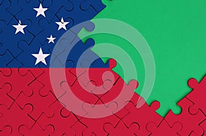 Samoa flag is depicted on a completed jigsaw puzzle with free green copy space on the right side