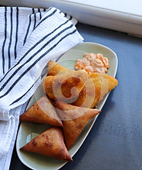 Samoosas and Half Moons on a tray