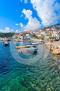 Fishing boats in Kokkari port with colourful Greek houses, Samos island, Greece