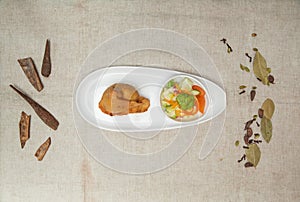 Samosa with chutey, sauce and salad served in a dish isolated on table top view of indian spices food