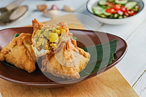 Samosa on a plate with sauce. Indian fried pastry