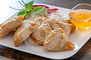 Samosa on a plate with sweet and sour sauce