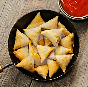 Samosas Indian snack in frying pan