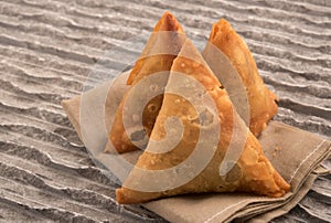 Samosas a spicy blend of vegetables or meat wrapped in a deep fried triangular pastry parcel.