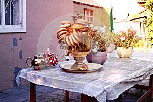samovar and bagels on table with linen tablecloth on the dacha