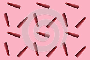 Sample background texture of many tubes of lipstick in pop art style on a pink background, concept decorative cosmetics