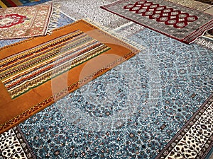 a sample of five handmade wool and silk carpets, typical turkish handmade kilim carpets and rugs in a Turkish carpet store