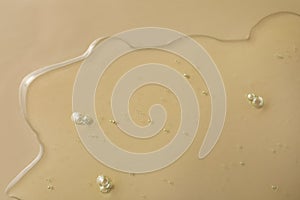 Sample of hydrophilic oil on beige background, top view