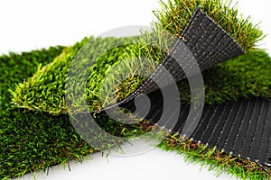 Sample pieces of green artificial grass of different thickness