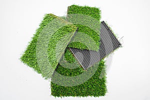 Sample pieces of green artificial grass of different thickness