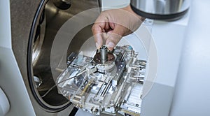 The sample is placed in a high magnification camera, used by machines