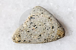 sample of polished andesite rock on white marble