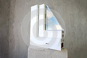 Sample PVC window stands on a concrete photo