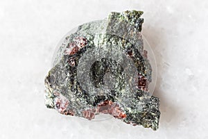 sample of pyrope garnets in rough rock on white
