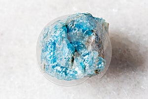 sample of raw apatite rock on white marble